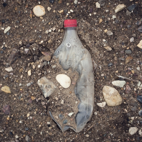 plastic bottle on the ground as plastic waste
