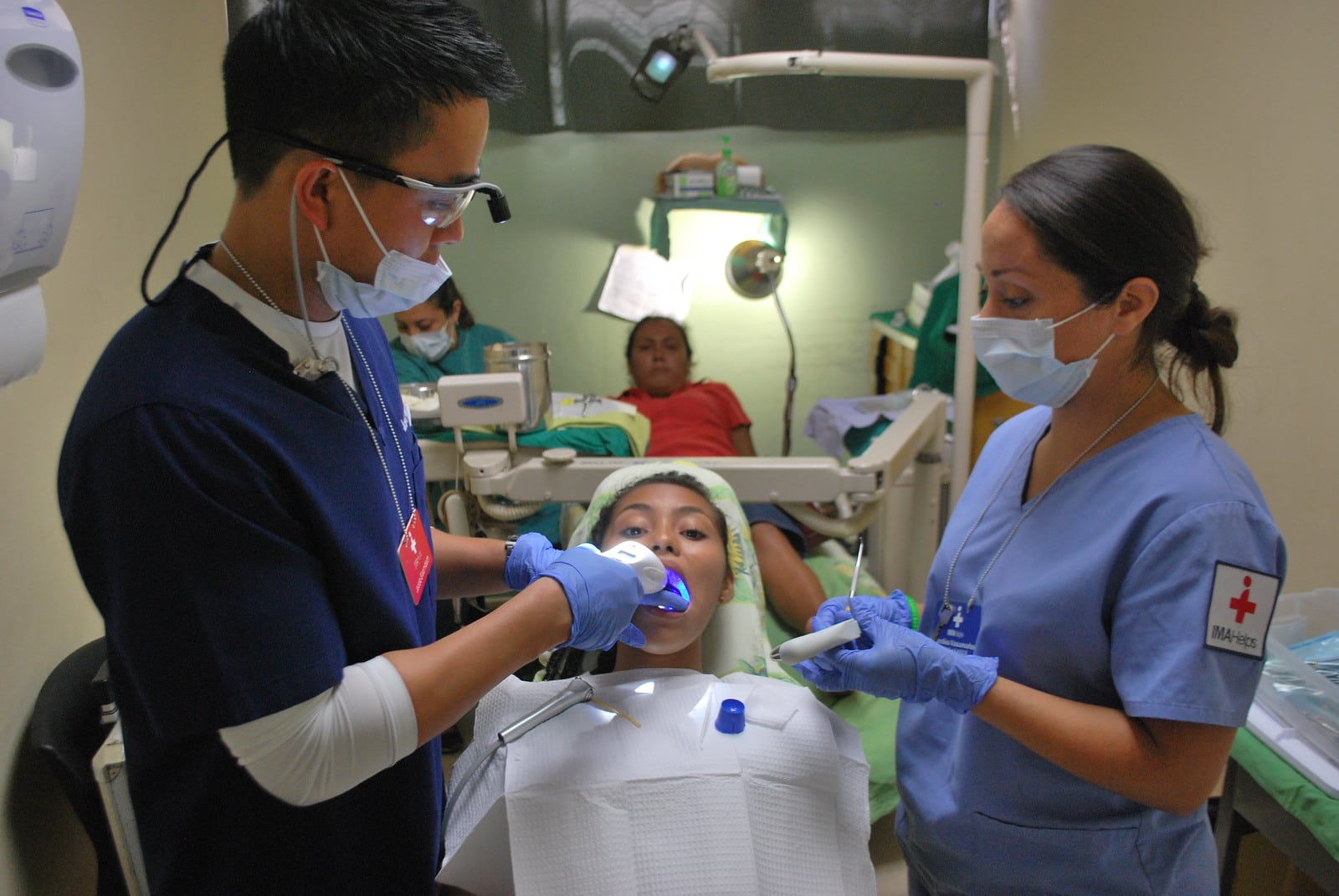 Dentists work on patients at a makeshift clinic in a hospital in El Salvador.