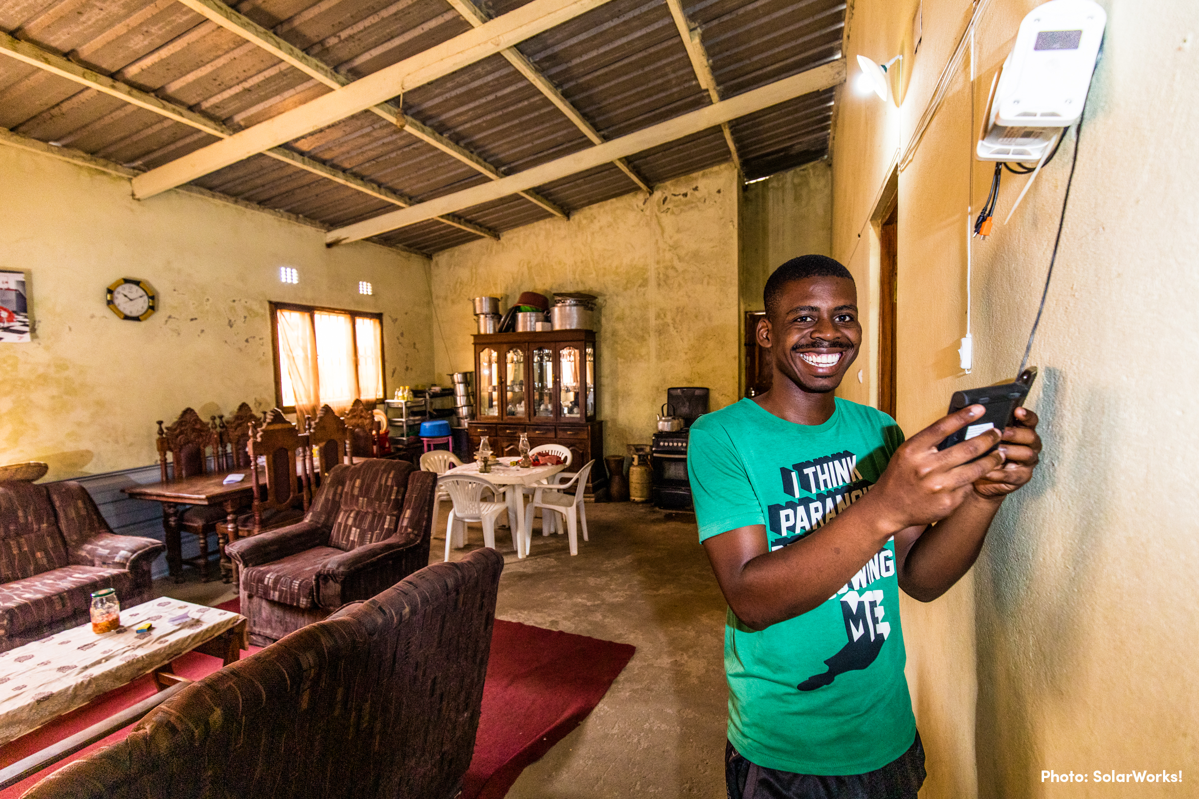 A man uses solar-powered appliances.